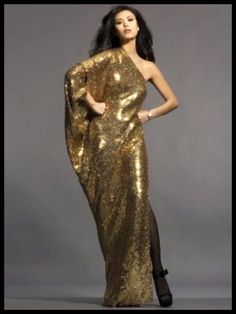 a woman in a gold dress is posing for a magazine cover photo with her hands on her hips