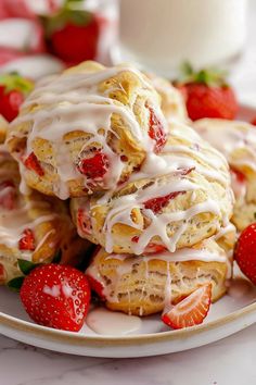 strawberry shortcakes with icing and strawberries on a plate