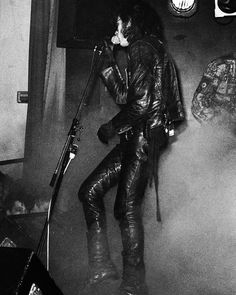 black and white photograph of a man singing into a microphone