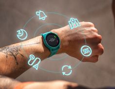 a man with tattoos on his arm is looking at a smart watch that has icons coming out of it