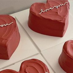 three heart shaped cakes sitting on top of each other