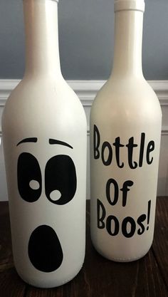 two bottles that have faces painted on them