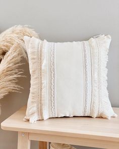 a white pillow sitting on top of a wooden table