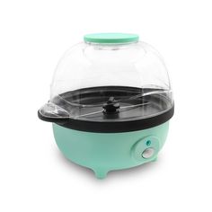 a small green and black ice cream dispenser sitting on top of a white surface