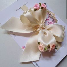 a close up of a bow with flowers on it's headband and ribbon