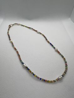 Colorful seed bead necklace with pearls.  Gold finishes. Handmade Pearl Beaded Necklaces For Festivals, Handmade Pearl Beaded Necklace For Festivals, Handmade Multicolor Pearl Necklace, Multicolor Beaded Pearl Necklace For Summer, Summer Multicolor Beaded Pearl Necklace, Bohemian Multicolor Pearl Chain Necklace, Multicolor Bohemian Pearl Chain Necklace, Multicolor Beaded Pearl Necklace For Beach, Multicolor Pearl Necklace With Tiny Beads And Adjustable Fit