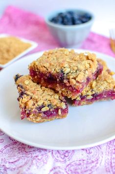 two pieces of blueberry crumbler bars on a white plate