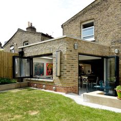 a brick house with an open patio and sliding glass doors