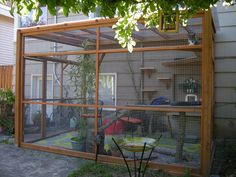 an outdoor area with a caged in bird house