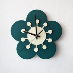 a clock that is on the side of a wall with dots and circles around it