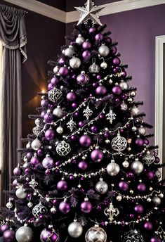 a decorated christmas tree with purple and silver ornaments