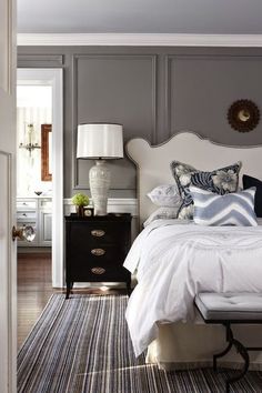 an instagramted photo of a bedroom with gray walls and white bed linens