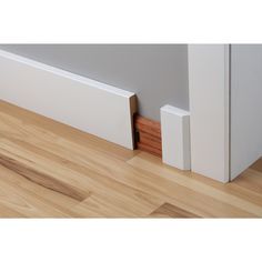 the corner of a room with wood flooring