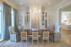 an elegant dining room with chandelier and chairs