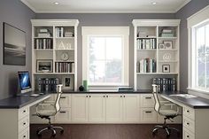 a home office with two desks and bookshelves