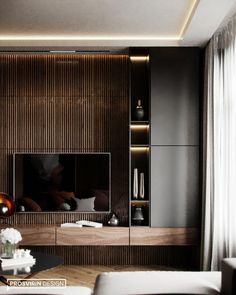 a modern living room with dark wood paneling and white furniture, including a large television