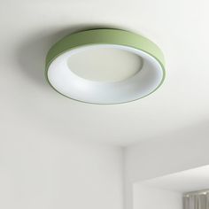 a green and white circular light fixture in a room