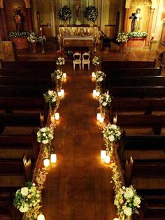 the aisle is lined with candles and flowers