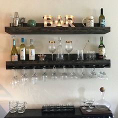 there are many wine glasses on the shelf