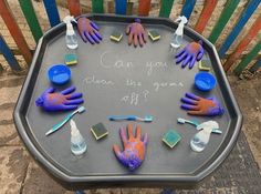 a table with painted hands and scrubs on it that says can you clean the grime off?