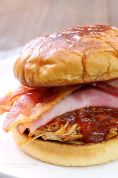 a close up of a sandwich on a plate with meat and cheese in the middle