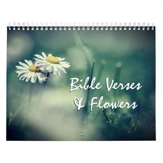 a wall calendar with the words bible verse and flowers on it in front of a blurry background