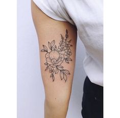 a woman with a flower tattoo on her arm