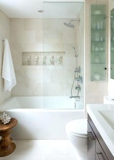 a bathroom with a toilet, sink and bathtub next to a shower stall in it