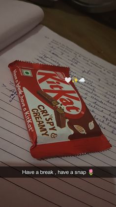 a piece of chocolate bar sitting on top of a notebook