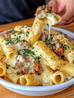 a bowl filled with pasta covered in sauce and parmesan cheese