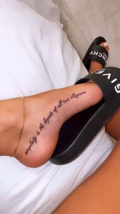 a woman's foot with a tattoo on it that says, there is no place for