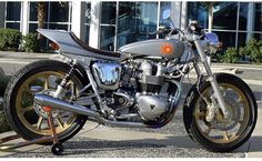 a silver motorcycle parked in front of a building