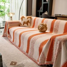 an orange and white striped couch in a living room