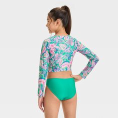 Add a touch of tropical style with the Abstract Tropical Jungle Flowers Bikini Set from art class™. This three-piece bikini set includes a bikini top and long-sleeve rash guard with an abstract tropical print, plus a solid green bikini bottom to complete the look. Made from recycled polyester with stretchy spandex, this swimwear set offers comfort during waterside activities. Plus, with a UPF 50+ rating, these pieces help keep their skin shielded from the sun's rays. art class™: One-of-a-kind lo Stretch Tankini For Beach Playwear, Playful Green Swimwear With Uv Protection, Playful Green Tankini For Poolside, Green Printed Swimwear For Play, Green Fitted Playful Tankini, Playful Fitted Green Tankini, Playful Green Printed Swimwear, Playful Green Swimwear For Beach Party, Playful Green Fitted Swimwear