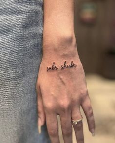 a woman's hand with a tattoo saying salt and shaker on the wrist