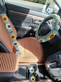 the interior of a car with sunflowers on the dash board and steering wheel