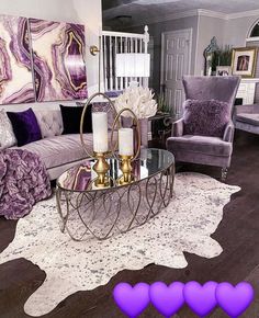 a living room filled with furniture and a rug on top of a hard wood floor