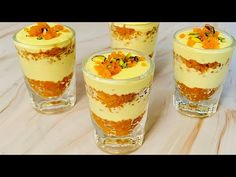 three glasses filled with dessert sitting on top of a table