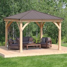 a wooden gazebo sitting on top of a lush green field