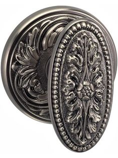 an ornately designed door knob with decorative design on the front and back sides, in antique