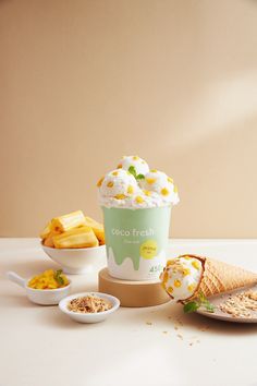 an ice cream sundae and other desserts on a white countertop with a light brown wall in the background