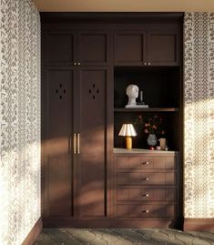 a brown cabinet with two lamps on top of it and some flowers in the vase