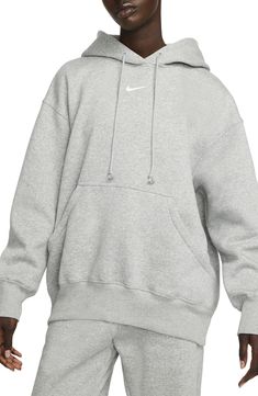 Exaggerated features like an oversized kangaroo pocket and extra tall ribbing add to the roomy feel of this sporty hoodie with a cozy brushed fleece interior. Drawstring hood 80% cotton, 20% polyester Machine wash, dry flat Imported Nike Sportswear Phoenix Fleece, Sporty Hoodie, Grey Nike Hoodie, Nike Sportswear Women, Polo Sport Ralph Lauren, Zip Hoodies, Loungewear Luxury, Nike Shox, Oversized Pullover