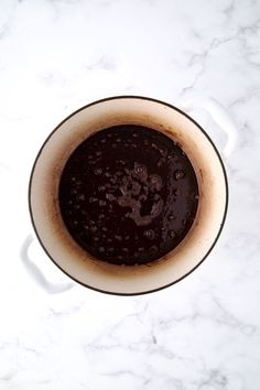 a cup filled with liquid sitting on top of a white counter