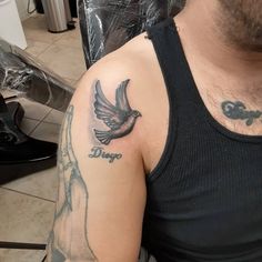 a man with a bird tattoo on his arm