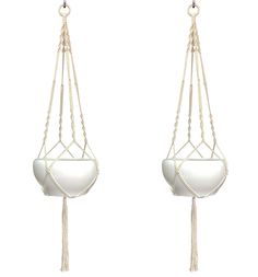 two white macrame earrings with tassels hanging from them