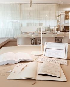 an open laptop computer sitting on top of a table next to a book and mouse