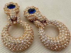 "Breathtaking CINER Moghul Sapphire Blue Cabochon Diamante Clip On Statement Earrings c. 1970s-1980s -Absolutely perfect icy doorknocker clip earrings completely covered in small clear crystals and accented by sapphire glass cabochons  -Signed Ciner -Excellent vintage condition, all stones intact -Clip ons -Size: 2 1/8\" long x 1 3/16\" wide" Ciner Jewelry, Clear Crystals, San Antonio Tx, Sapphire Blue, Clip Earrings, Clear Crystal, San Antonio, Clip On, Blue Sapphire