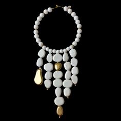 This elegant choker necklace measures 16 inches, complemented by a striking strand of beads that extends to 28 inches.   Featuring dangling acrylic white beads adorned with gold accent beads, this versatile piece serves as a bold statement accessory suitable for both formal and informal occasions.  The pure white beads create a stunning visual impact, ensuring this necklace stands out effortlessly in any setting. White Pearl Chain Choker Necklace, Modern White Pearl Chain Necklace, White Pearl Drop Choker Jewelry, Elegant White Beaded Choker Necklace, Elegant White Bib Necklace Choker, Adjustable White Beaded Necklace With Dangling Beads, Adjustable White Jewelry With Dangling Beads, White Adjustable Jewelry With Dangling Beads, White Pearl Drop Beaded Choker Necklace