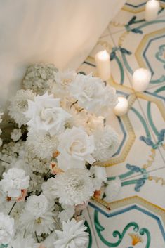 white flowers and candles are on the floor